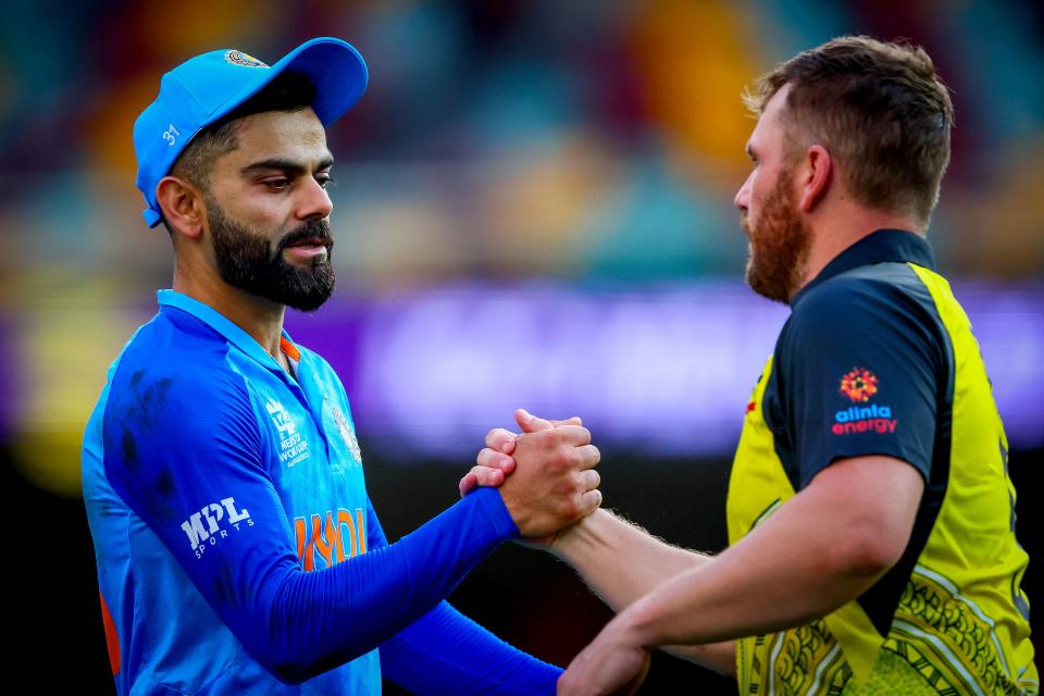 Australia's captain Aaron Finch (pictured right) shakes hands with Virat Kohli (pictured left).