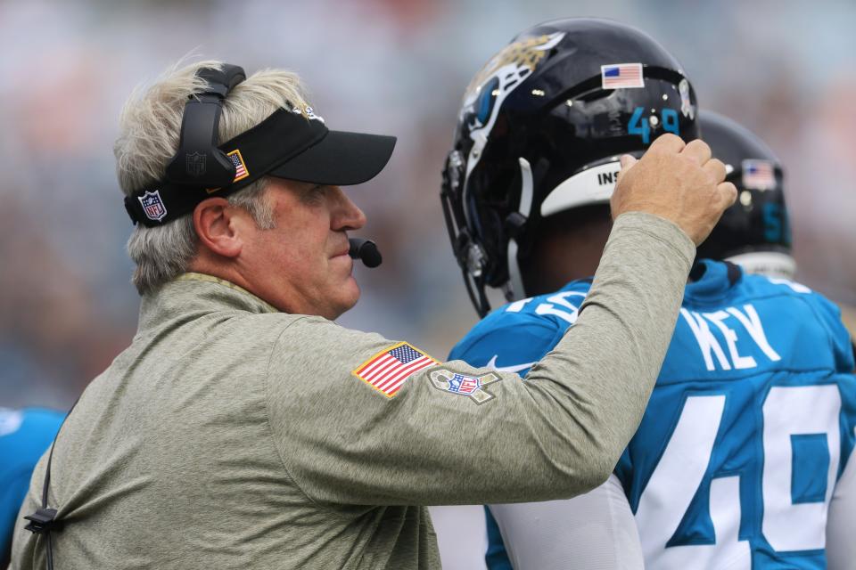 Jacksonville Jaguars head coach Doug Pederson congratulates Jacksonville Jaguars defensive end Arden Key (49) on a defensive stop during the first quarter of a regular season NFL football matchup Sunday, Nov. 6, 2022 at TIAA Bank Field in Jacksonville. The Jacksonville Jaguars held off the Las Vegas Raiders 27-20. [Corey Perrine/Florida Times-Union]