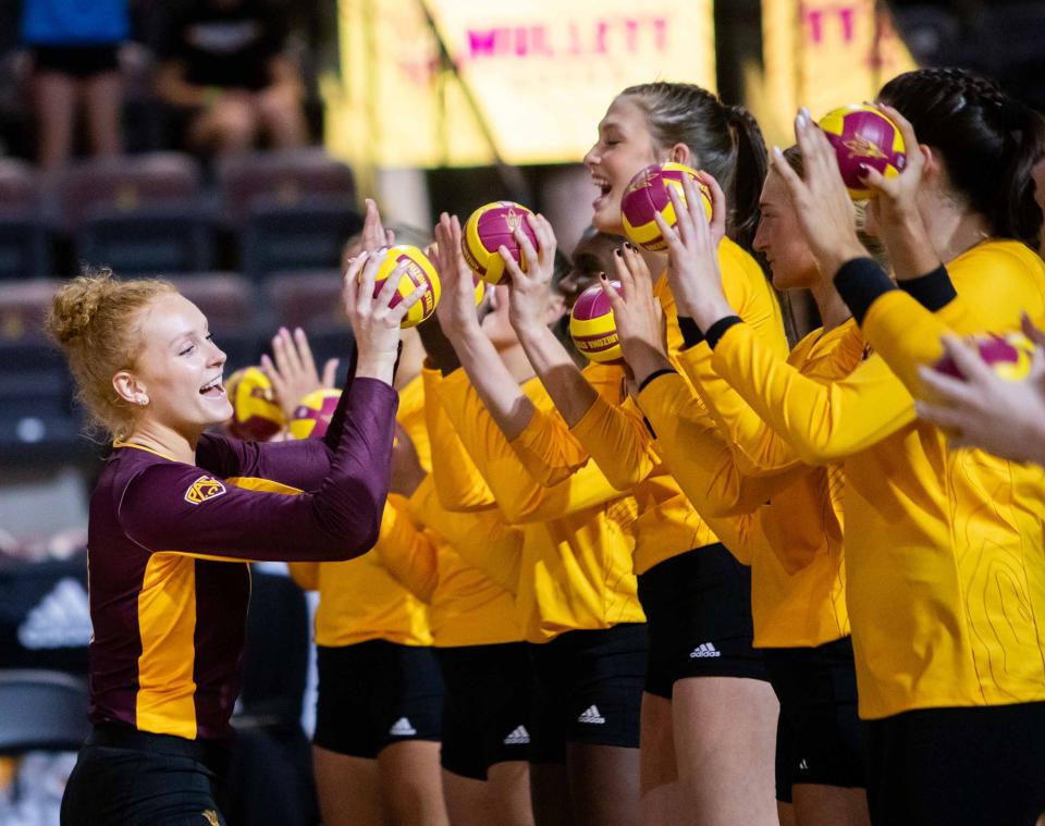 ASU women's volleyball libero Mary Shroll (11) high-fives her teammates prior to the game at Mullett Arena in Tempe on Sept. 21, 2023.
