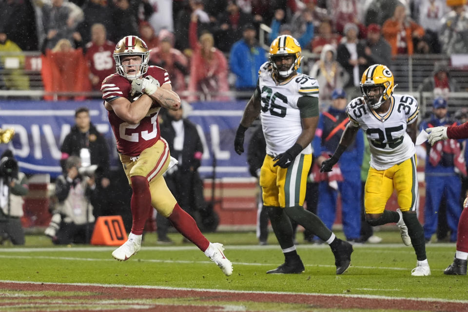 San Francisco 49ers running back Christian McCaffrey (23) scores a rushing touchdown during the second half of an NFL football NFC divisional playoff game against the Green Bay Packers Saturday, Jan. 20, 2024, in Santa Clara, Calif. (AP Photo/Godofredo A. Vásquez)