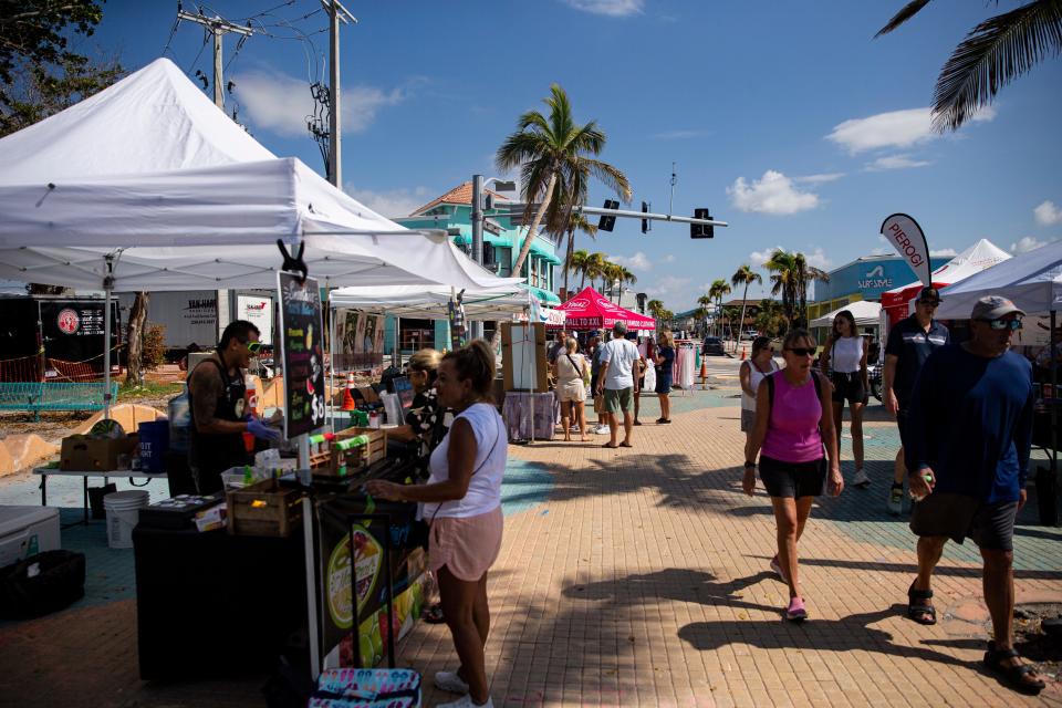 Patrons peruse the Farmers Market at Times Square on Fort Myers Beach on Friday, Sept. 8, 2023. The market recently opened on Friday’s at the location which was decimated in Hurricane Ian.