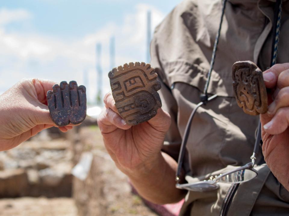 Archaeologists of the Pacopampa Archaeological Project hold pieces of pottery of a 3,000-year-old tomb which they believe might have honored an elite religious leader in the Andean country some three millennia ago, in Pacopampa, Peru August 26, 2023.