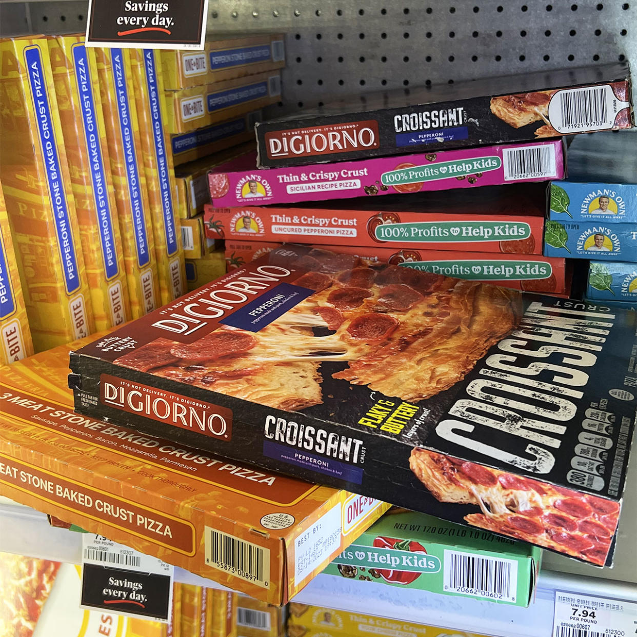 stacked frozen pizzas at grocery store