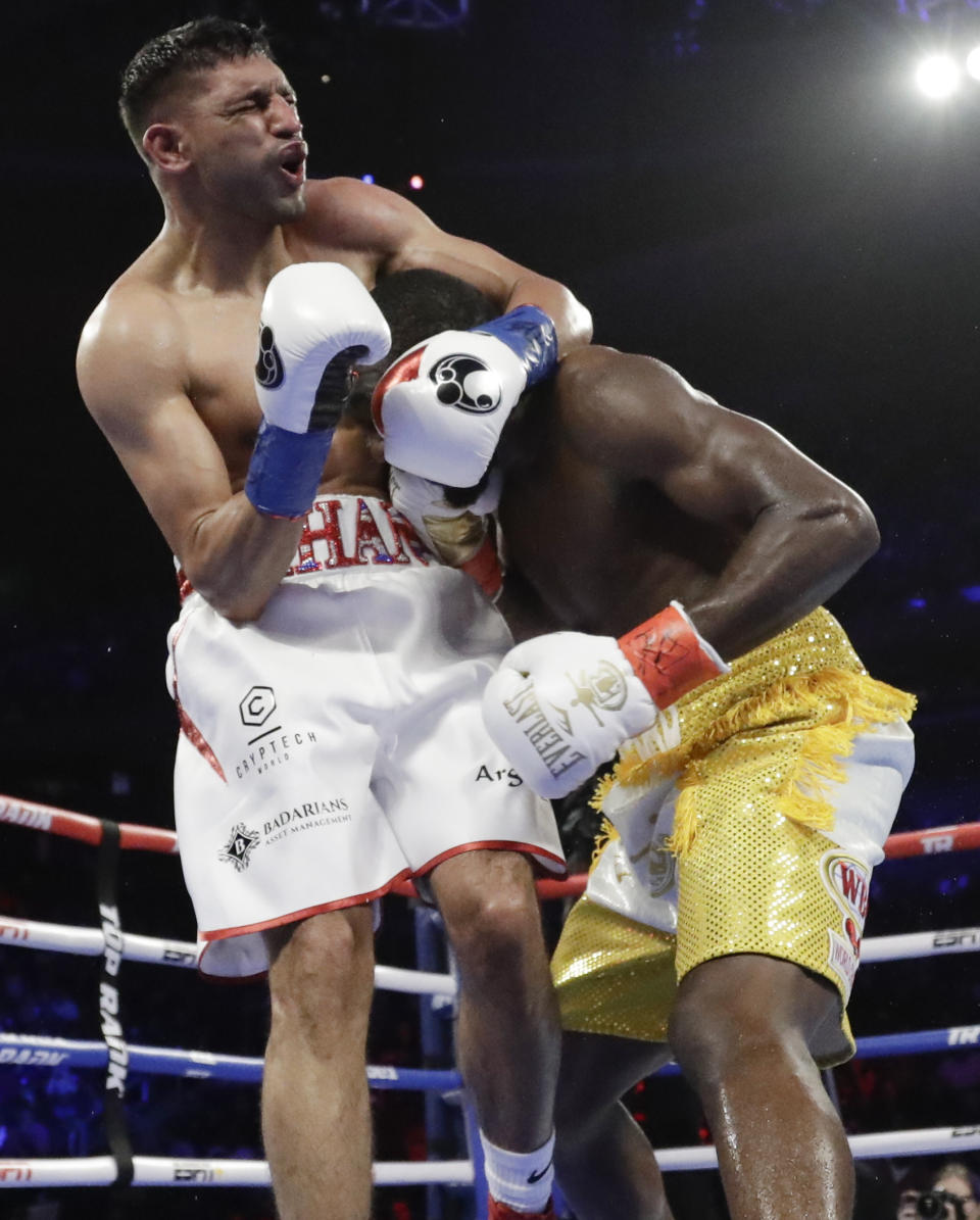 England's Amir Khan reacts to a low blow by Terence Crawford during the sixth round of a WBO world welterweight championship boxing match Sunday, April 21, 2019, in New York. Crawford won the fight when Kahn could not continue. (AP Photo/Frank Franklin II)