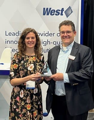 West team member Kate Giannantonio accepts award from INTERPHEX representative on behalf of West