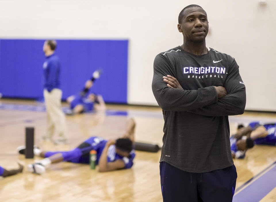 FILE - In this March 17, 2017, file photo, Creighton assistant coach Preston Murphy, right, stands as players warm up during practice in Omaha, Neb. The NCAA put Creighton men's basketball program on two years' probation and docked scholarships each of the next two seasons on Tuesday, June 22, 2021, after alleging that a former assistant coach accepted cash from a management agency. The committee on infractions said Preston Murphy did not take any other action after the meeting in a Las Vegas hotel. But the meeting itself violated NCAA rules because the receipt of money formalized a business relationship in which the management company could attempt to use the coach to gain access to Creighton players. (AP Photo/Nati Harnik, File)