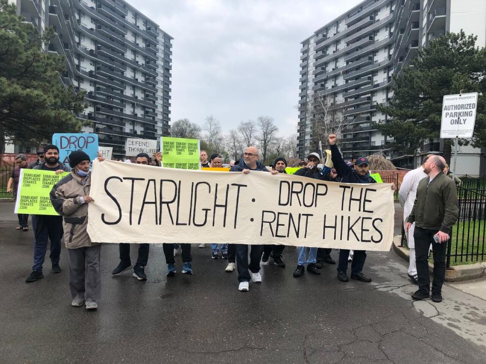 Striking tenants at 71, 75, and 79 Thorncliffe Park Drive gathered in front of their apartment complexes on Sunday to mark almost one year of withholding rent in protest of proposed above guideline increases to their buildings. (Spencer Gallichan-Lowe/CBC - image credit)