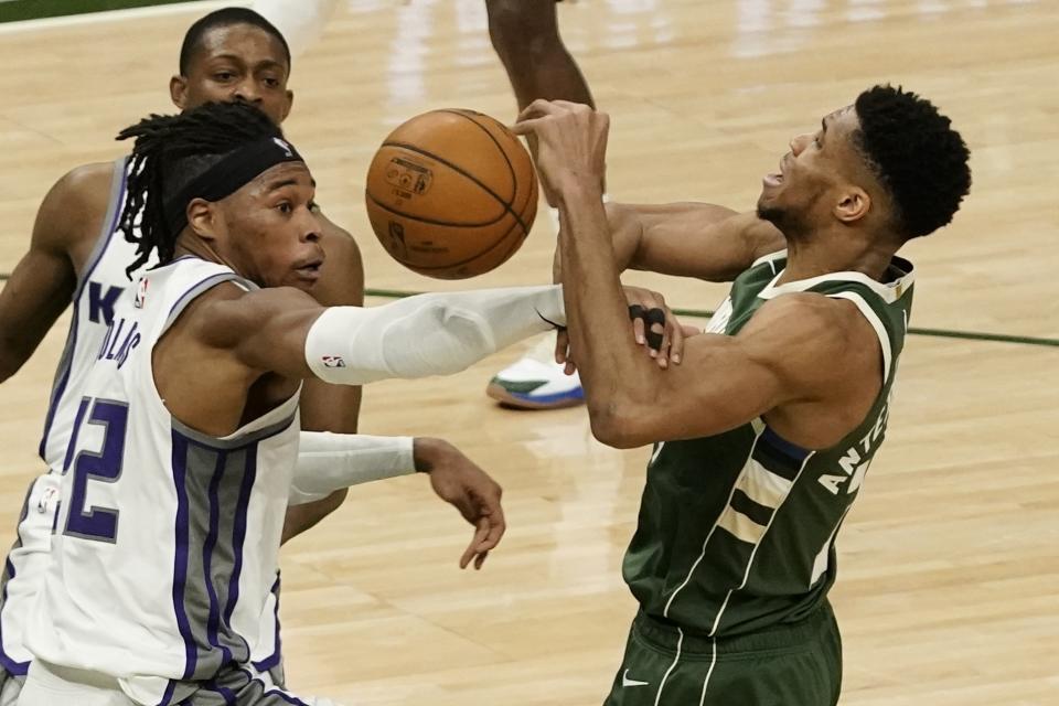 Sacramento Kings' Richaun Holmes fouls Milwaukee Bucks' Giannis Antetokounmpo during the second half of an NBA basketball game Sunday, Feb. 21, 2021, in Milwaukee. (AP Photo/Morry Gash)