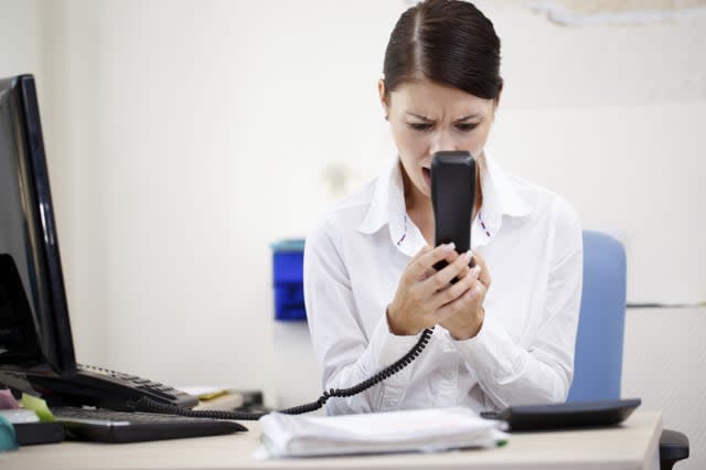 Angry woman shouting at phone