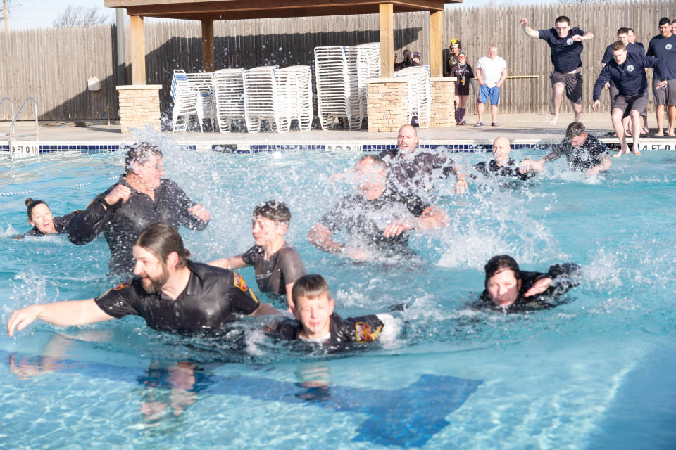 Members of the Amarillo Police Department move quickly across the pool at the Polar Plunge Saturday morning at the Amarillo Town Club.