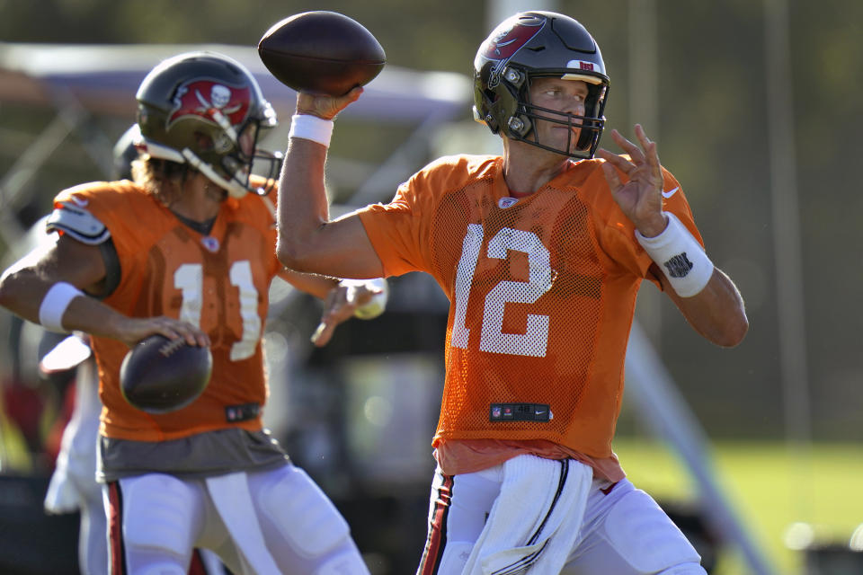 FILE - In this Aug. 24, 2020, file photo, Tampa Bay Buccaneers quarterback Tom Brady (12) and quarterback Blaine Gabbert (11) throw passes during an NFL football training camp practice in Tampa, Fla. No one is traveling more of a distance, at least achievement-wise, than Brady. When it comes to meaningfulness, though, the conversation begins and ends with the six-time Super Bowl champ. At 43, when most football players are looking for tee times, not touchdowns, Brady joins the perennial underachieving Buccaneers. (AP Photo/Chris O'Meara, File)