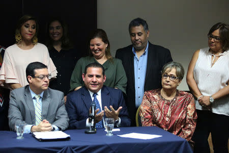 Relatives of former Salvadoran army officers participate in a news conference to announce that the Supreme Court suspended arrest warrants against soldiers for their alleged involvement in the 1989 massacre of Jesuit priests during the civil war, in San Salvador, El Salvador, August 22, 2017. REUTERS/Jose Cabezas