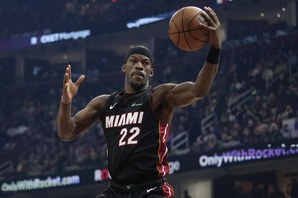 Miami Heat forward Jimmy Butler (22) grabs a rebound during the first half of team's NBA basketball game against the Cleveland Cavaliers, Wednesday, Nov. 22, 2023, in Cleveland. (AP Photo/Sue Ogrocki)