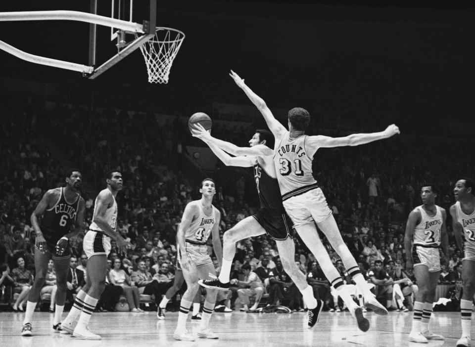 Boston’s John Havlicek drives to the basket for two points against the Lakers in the final game of the NBA title playoff at Los Angeles May 3, 1968. Mel Counts, 7 feet tall, tries to stop him. Lakers’ Jerry West at left. Boston won, 124-109 to take the title, 4 games to 2. AP Photo/HF