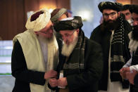 Abdul Salam Hanafi, a deputy prime minister in the Taliban's interim government, left, speaks with acting Foreign Minister of Afghanistan, Taliban official Amir Khan Muttaqi during talks involving Afghan representatives in Moscow, Russia, Wednesday, Oct. 20, 2021. Russia hosted talks on Afghanistan on Wednesday involving senior representatives of the Taliban and neighboring nations, a round of diplomacy that underlines Moscow's clout. Russian Foreign Minister Sergey Lavrov opened the talks and emphasized that "forming a really inclusive government fully reflecting the interests of not only all ethnic groups but all political forces of the country" is necessary to achieve a stable peace in Afghanistan. (AP Photo/Alexander Zemlianichenko, Pool)