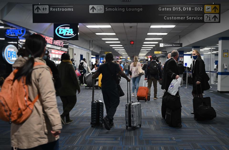 Travelers crowd a terminal at Dulles International Airport outside of Washington, D.C., on Sunday, Dec. 27. The Transportation Security Administration says it screened nearly 1.3 million passengers Sunday, more than any other day since the pandemic began.