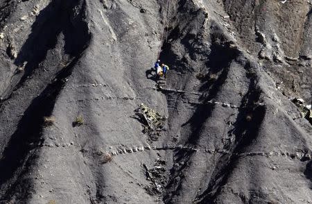 French gendarmes work amongst the debris of the Airbus A320 at the site of the crash, near Seyne-les-Alpes, French Alps March 27, 2015. REUTERS/Gonzalo Fuentes