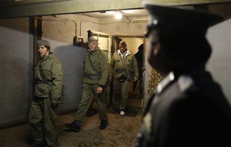 Thomas Krueger, dressed as NVA major, waits for participants for an appeal during the 'reality event' one night at the 'Bunker-Museum' in Rennsteighoehe near the eastern city of Ilmenau October 12, 2013. REUTERS/Ina Fassbender