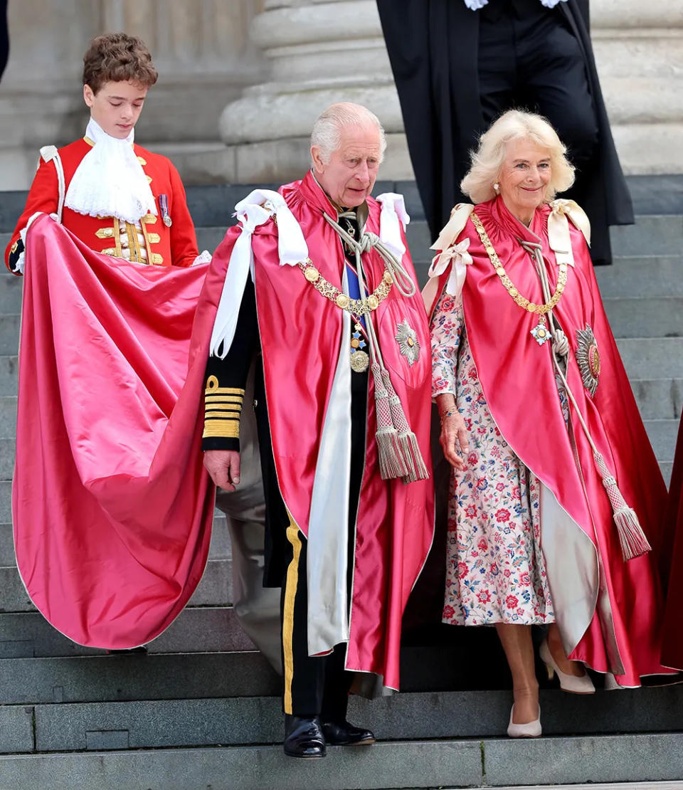 King Charles and Queen Camilla wearing red royal robes