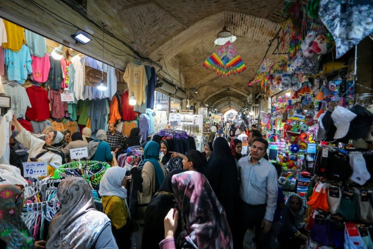 People shop at a bazaar in Iran's central city of Isfahan after a reported Israeli strike in the area (Rasoul SHOJAEI)