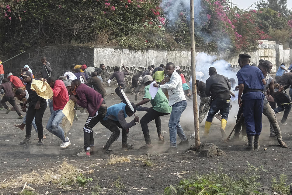 Demonstrators clash with police during a protest against the United Nations peacekeeping force (MONUSCO) deployed in the Democratic Republic of the Congo in Sake, some 15 miles (24 kms) west of Goma, Wednesday July 27, 2022. Officials say more than 15 people have been killed and dozens injured during the demonstrations against the UN mission in the country, heading into their third day. (AP Photo/Moses Sawasawa)