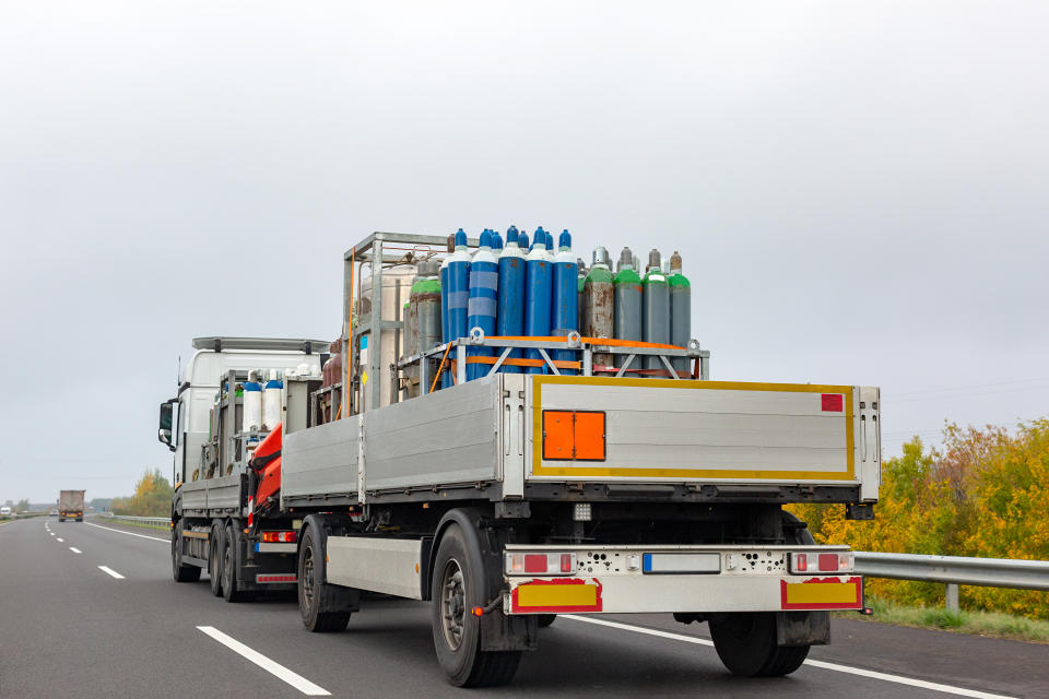 Transportation of cylinders with oxygen for patients with coronavirus. Truck delivering gas cylinders for medical purposes