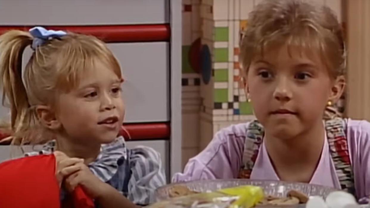  Michelle (one of the Olsen twins) talks to Stephanie (Jodie Sweetin) in their room in an episode of Full House. 