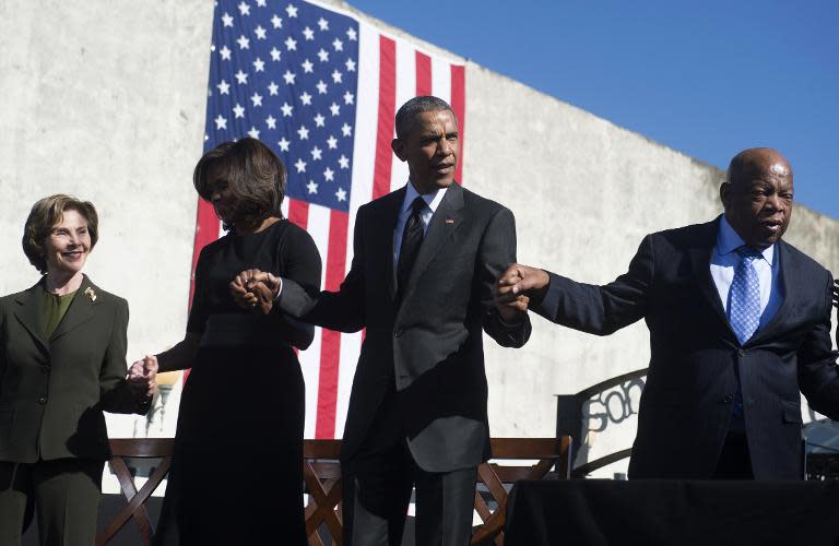 (L-R) Former first lady Laura Bush, First Lady Michelle Obama, President Barack Obama and Representative John Lewis, mark the 50th Anniversary of the Selma to Montgomery civil rights marches at Edmund Pettus Bridge in Selma, Alabama, March 7, 2015