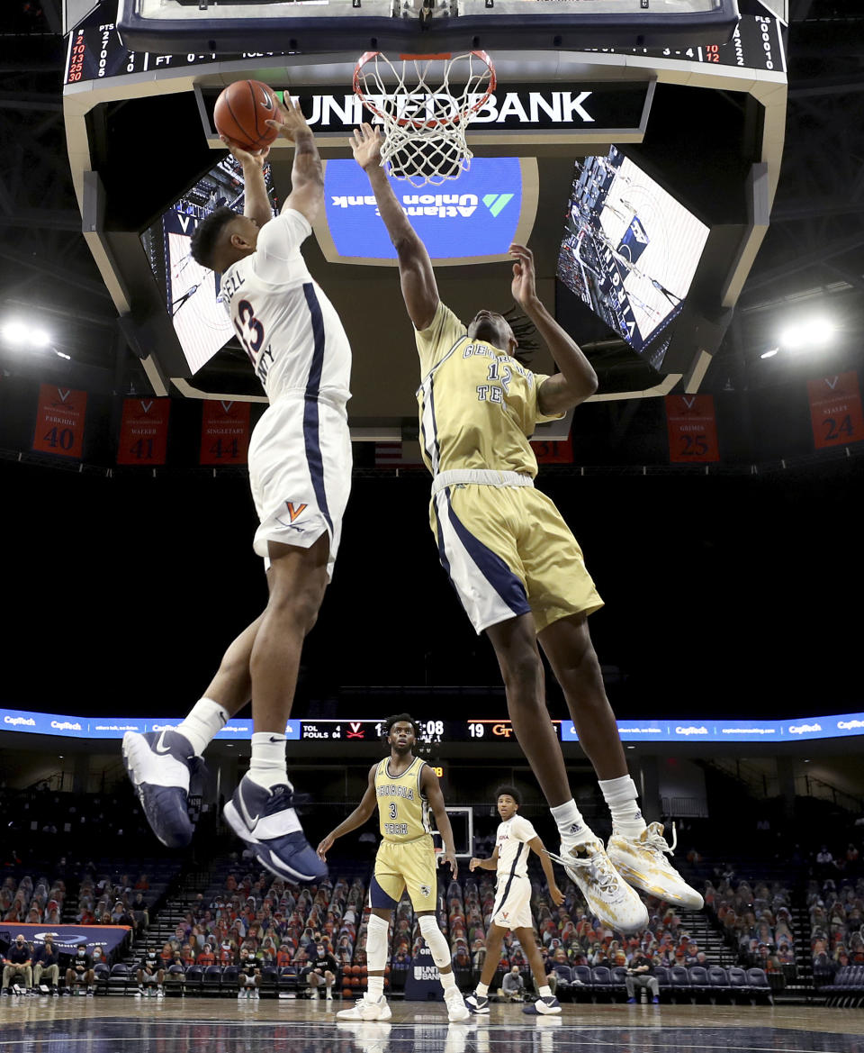 Virginia guard Casey Morsell (13) shoots next to Georgia Tech forward Khalid Moore (12) during an NCAA college basketball game Saturday, Jan. 23, 2021, in Charlottesville, Va. (Andrew Shurtleff/The Daily Progress via AP, Pool)