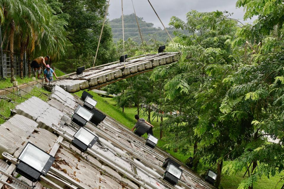 Taiwanese workers secure platforms in anticipation for Typhoon Krathon at the riverside in New Taipei City, Taiwan (EPA)