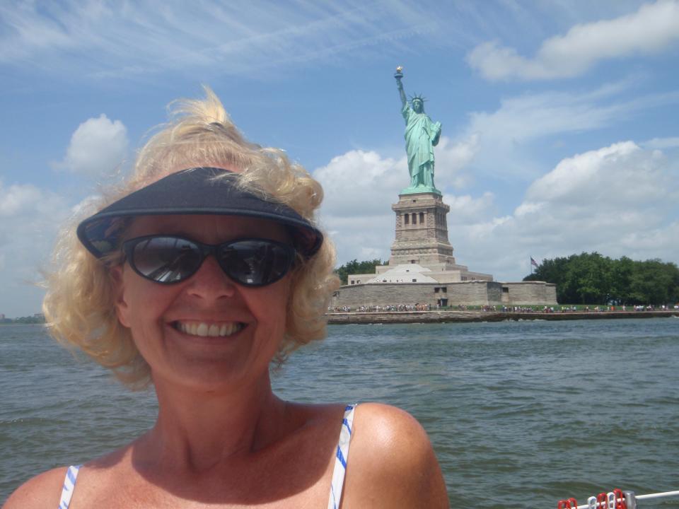 Adventurer, author and blogger Kimberly J. Ward with the Crew of Three sails past Lady Liberty.