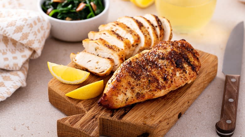 sliced chicken breast on cutting board 