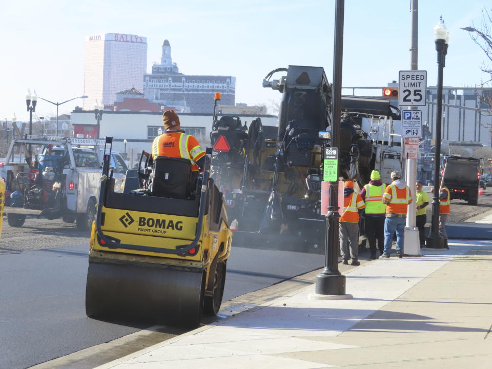 Heavy equipment repaves part of Atlantic Avenue in Atlantic City, N.J. on Dec. 13, 2023 as the city's controversial "road diet" project to narrow the main roadway from two lanes in each direction to one began. Five casinos and a hospital are asking a judge to order a halt to the plan, saying it could dangerously worsen traffic in the seaside gambling resort. (AP Photo/Wayne Parry)