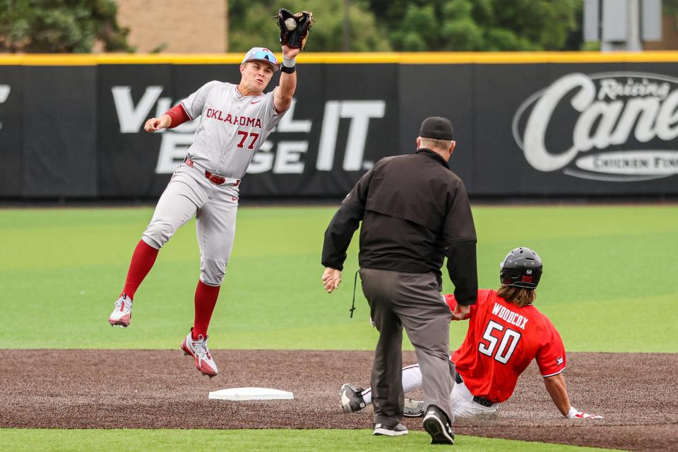 Oklahoma shortstop Jaxon Willits (77) catches a throw to second to tag out Texas Tech's Drew Woodcox during a Big 12 game Saturday at Dan Law Field/Rip Griffin Park. Woodcox was caught stealing on the play.