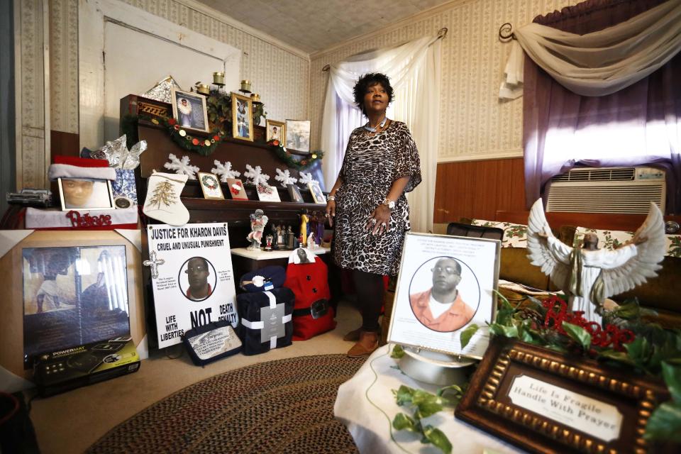 In this Jan. 18, 2017 photo, Chrycynthia Davis, mother of Kharon Davis, shows the Associated Press her memory area of her son during an interview, in Dothan, Ala. Kharon Davis was 22-years-old when he was arrested on a capitol murder charge in 2007 and booked into the Houston County Jail. Davis has spent nearly a third of his life held without bond in the jail waiting for trial. (AP Photo/Brynn Anderson)