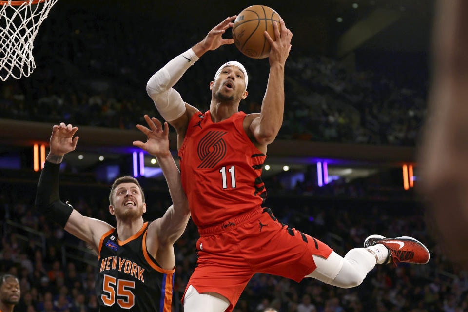 Portland Trail Blazers guard Josh Hart (11) drives to the basket past New York Knicks center Isaiah Hartenstein during the first half of an NBA basketball game Friday, Nov. 25, 2022, in New York. (AP Photo/Adam Hunger)