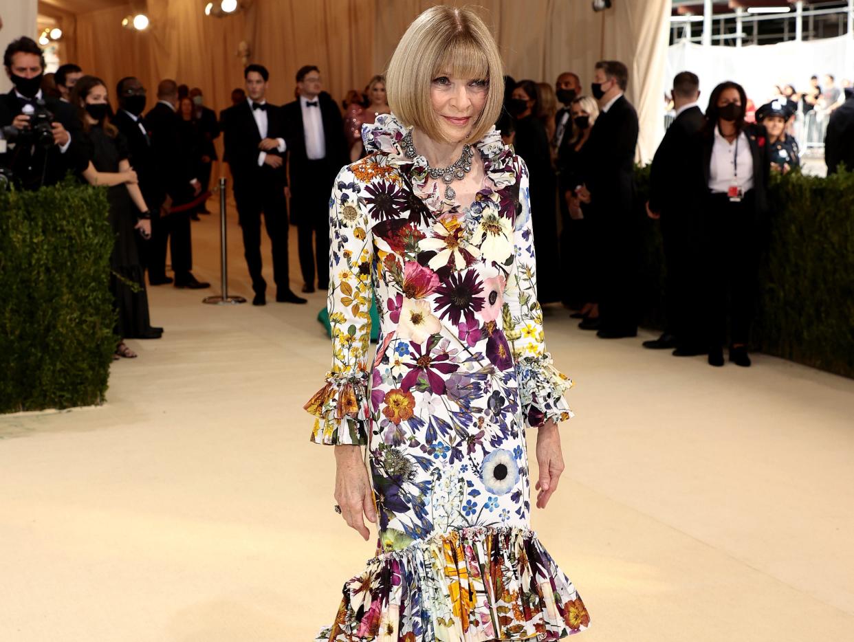 Anna Wintour wears a floral dress on the 2021 Met Gala red carpet.