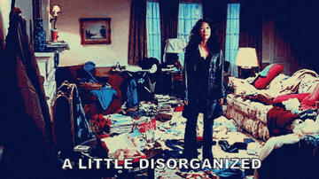 woman gestures to messy room and says "a little disorganized"