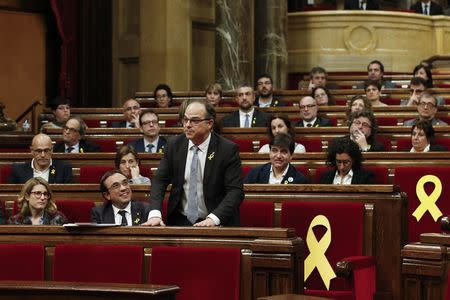 Catalan regional deputy Jordi Turull votes from his seat during his investiture session as new Catalan President at regional parliament in Barcelona, Spain, March 22, 2018. REUTERS/Albert Gea
