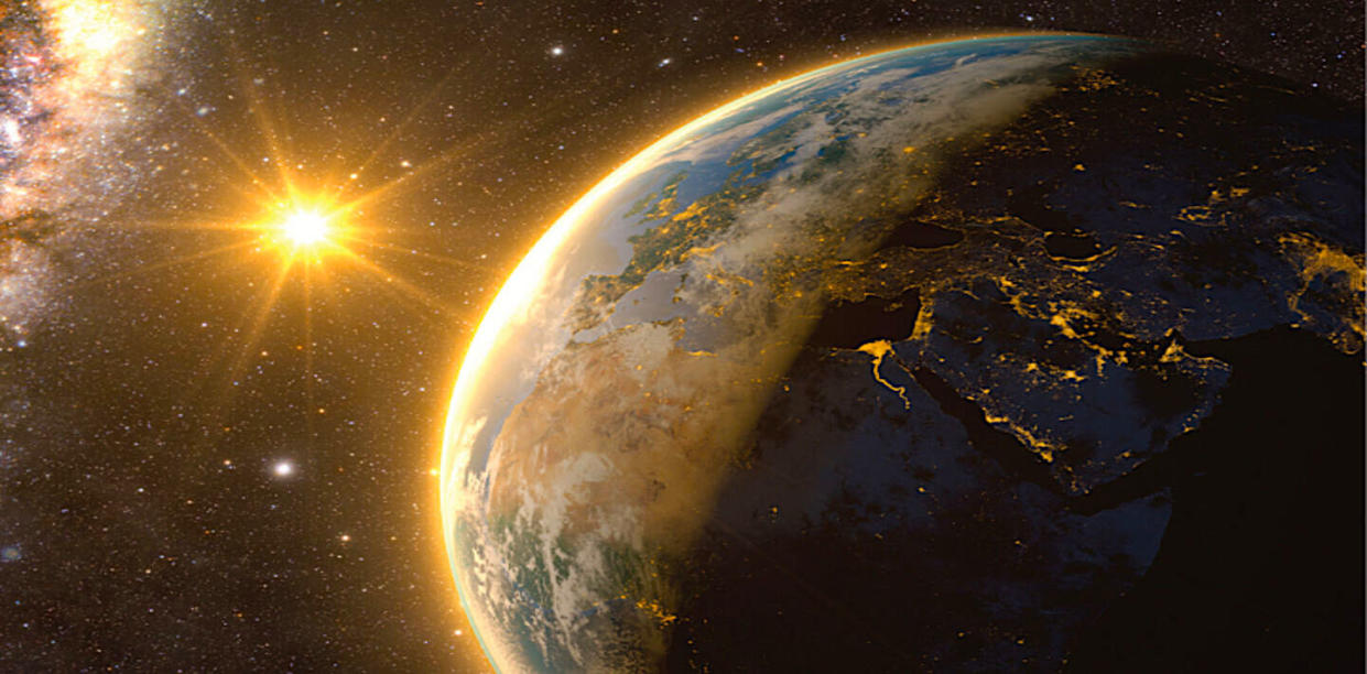  Illustration of earth with the bright sun in the background. 