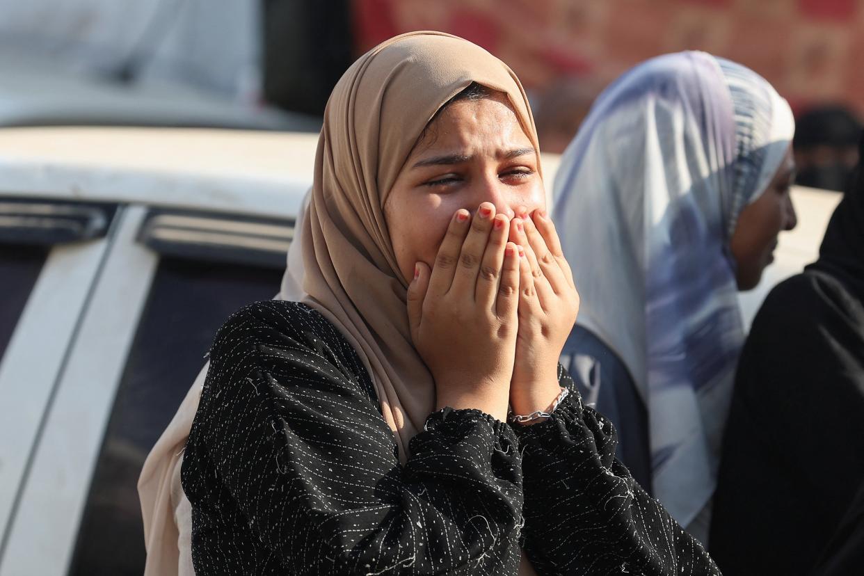 A mourner reacts near to the bodies of Palestinians killed in Israeli strikes, amid the Israel-Hamas conflict, at Al-Aqsa Martyrs Hospital in Deir Al-Balah in the central Gaza Strip, 20 August 2024 (Reuters)