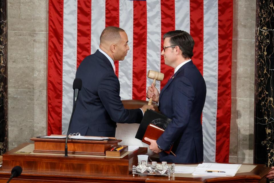 House Minority Leader Hakeem Jeffries, D-N.Y., left, hands the gavel to the newly elected Speaker of the House, Rep. Mike Johnson, R-La., on Oct. 25, 2023.