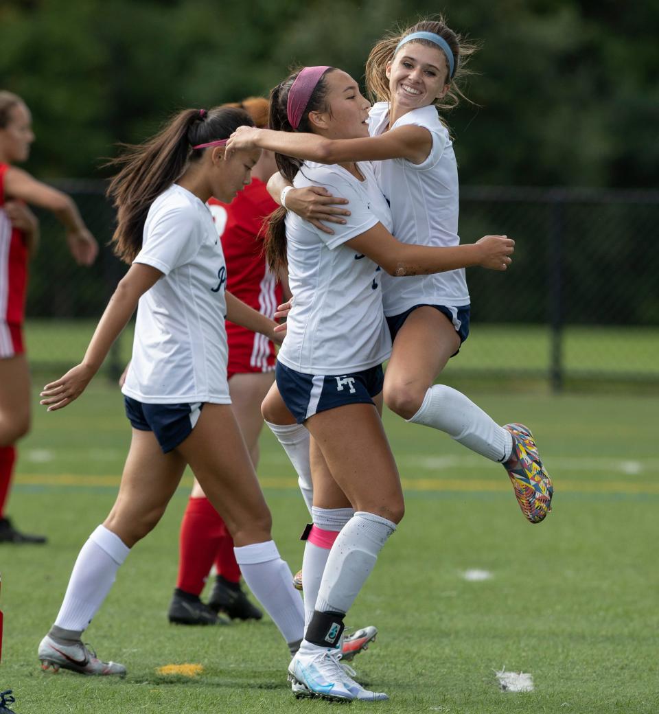 Freehold Ainsley Hailey Santiago jumps into the arms of Ainsley Moy who just scored a second half goal. Freehold Township Girls Soccer defeats Manalapan 4-0 in Manalapan, NJ on September 20, 2022. 