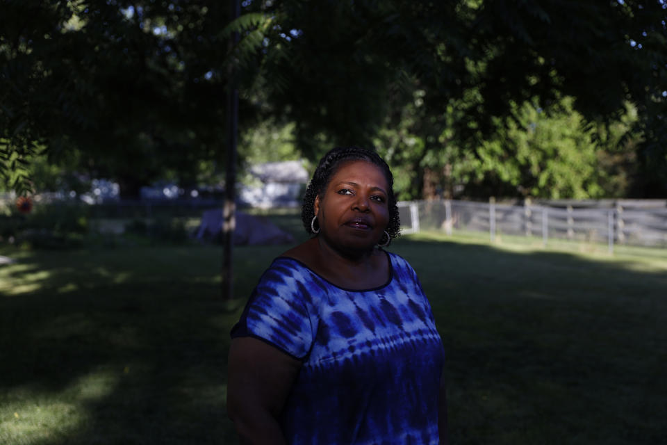 Pamela Davidson, a Knox County Board member, stands for a portrait in her yard in Galesburg, Ill., Monday, June 14, 2021. Davidson, 57, would love to see a federal infrastructure bill pour millions of dollars into the south Galesburg district she represents but she'd rather see that district redrawn for the first time in 60 years. (AP Photo/Shafkat Anowar)