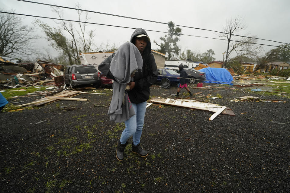 Chelsi Bovie holds her niece's dog that she rescued from her home after a tornado tore through the area in Killona, La., about 30 miles west of New Orleans in St. James Parish, Wednesday, Dec. 14, 2022. (Gerald Herbert/AP Photo)