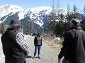 The mayor of Stewart, British Columbia, Gina McKay, center, meets with Alaska Gov. Mike Dunleavy, right, and Alaska state Sen. Bert Stedman at the U.S.-Canada border near Hyder, Alaska, on Thursday, April 22, 2021. Dunleavy said Alaska is in a fortunate position with its vaccine supply and wants to share it with people across the border in Stewart, British Columbia, a community that has close ties to Hyder. (AP Photo/Becky Bohrer)