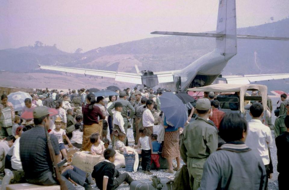 Galen Beery photographed displaced people, including Hmong and Laotian individuals, waiting to board evacuating flights leaving Laos at the Sam Thong airstrip in 1970.