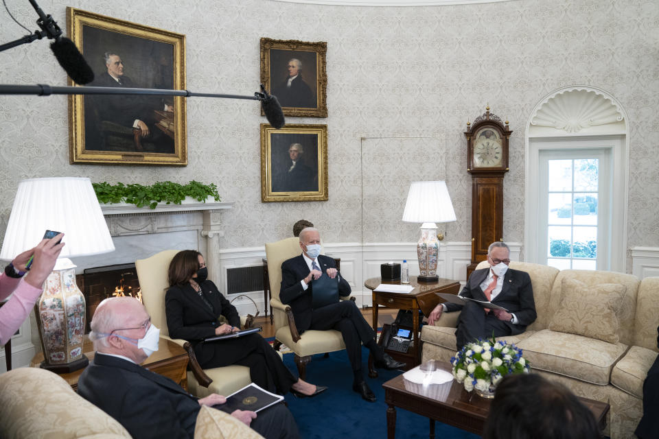 Vice President Kamala Harris, President Joe Biden, and Senate Majority Leader Sen. Chuck Schumer of N.Y., meet to discuss a coronavirus relief package, in the Oval Office of the White House, Wednesday, Feb. 3, 2021, in Washington. (AP Photo/Evan Vucci)