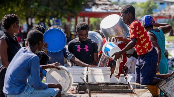 PHOTO: People displaced by gang war violence in Cite Soleil collect water from a well at the Hugo Chavez Square transformed into shelter living in inhumane conditions in Port-au-Prince, Haiti, Oct. 16, 2022.  (Ricardo Arduengo/Reuters)