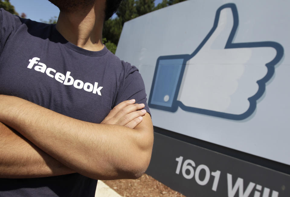 A Facebook worker waits for friends to arrive outside of Facebook headquarters in Menlo Park, Calif., Friday, Aug. 17, 2012. Facebook stock is trading at $19 and has lost half its market value since its May public offering. (AP Photo/Paul Sakuma)